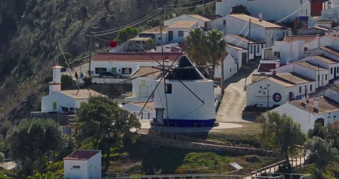 Aerial view of small village with windmill and picturesque rooftops, Odeceixe Video stock 310212199