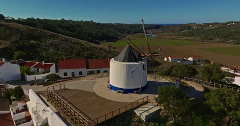 Aerial view of small village with windmill and picturesque rooftops, Odeceixe Stock Footage 310683313