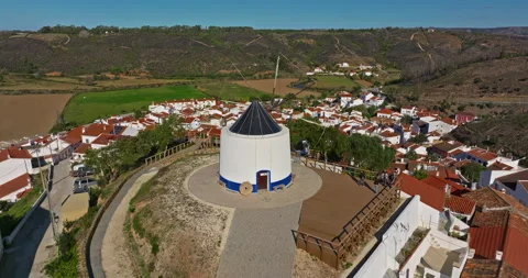 Aerial view of small village with windmill and picturesque rooftops, Odeceixe Stock Footage 311111528