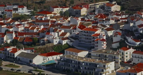 Aerial view of small village with windmill and picturesque rooftops, Odeceixe Stock Footage 311112565