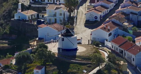 Aerial view of small village with windmill and picturesque rooftops, Odeceixe 스톡 동영상 311809592
