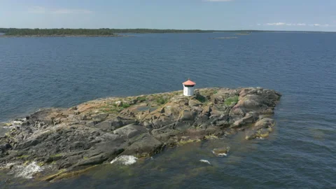 Aerial view of a small washed lighthouse on a remote island Stock Footage 134177403