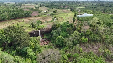 Aerial view of small waterfall below rice fields in Gia Lai, Vietnam 動画素材 337404608