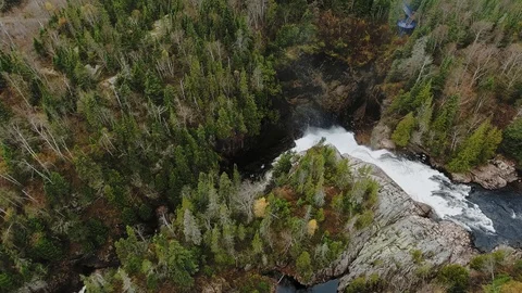 Aerial view of a small waterfall in a dense autumn forest. Aguasabon Falls Video stock 126077728