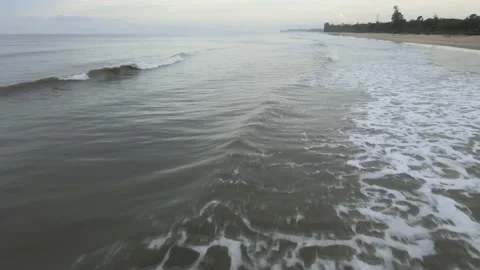 Aerial view of Small Waves Splashing on the Beach in Malaysia Stock Footage 147371181