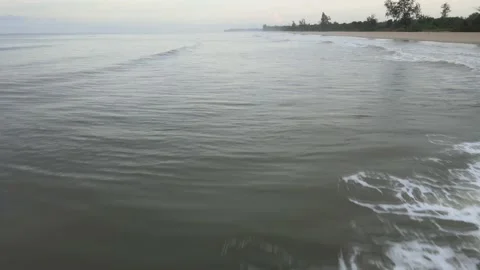 Aerial view of Small Waves Splashing on the Beach in Malaysia Stock Footage 147371308