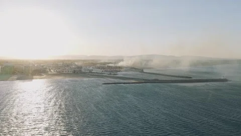 Aerial view of smoke rising from a fire near Camping Brasilia in Canet-en Stock Footage 346666022