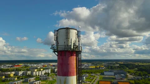 Aerial view of a smoke stack chimney tower with 5G and 6G radio transmitters at Stock Footage 317070853