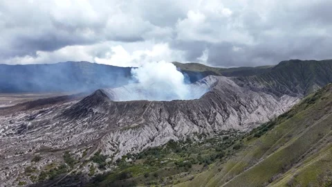 Aerial View of Smoking Mount Bromo Crater and Mountain Slopes East Java Indonesi Video stock 344892216
