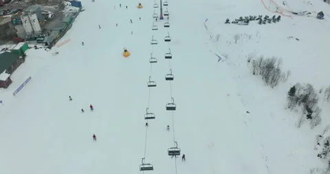 Aerial view smooth movement along the ski slopes in the ski resort of Stock Footage 140120476