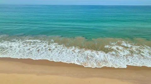 Aerial view smooth waves in blue sea hit on the beach. Video stock 235664332