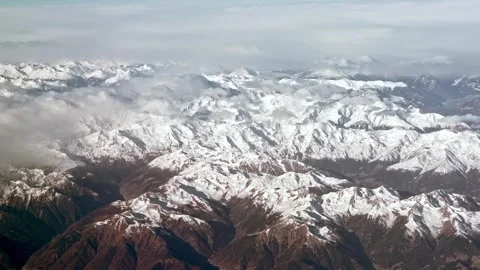 Aerial view of the snow capped Alps, rugged mountain peaks landscape. Stock Footage 290476141