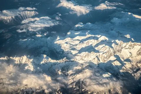 Aerial view of snow capped alps Stock Photos