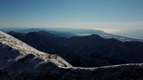 Aerial view of the snow-capped Corchia mountain, in the Apuan Alps, and Versilia Stock Footage 125857560