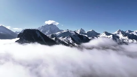Aerial View of Snow Capped Himalayan Peaks Above Flowing Clouds Tibet Видео 339311001