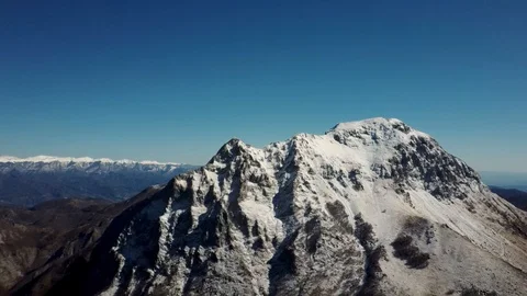 Aerial view of the snow-capped Mount Pania, in the Apuan Alps Stock Footage 125857693
