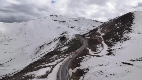 Aerial view of snow-capped mountain road at Sejila Mountain Pass G318 Tibet Stock Footage 306864968