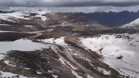 Aerial view of snow-capped mountain road at Sejila Mountain Pass G318 Tibet Stock Footage 306864975