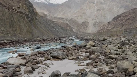 Aerial View of a Snow-Capped Mountain Valley in Pakistan, Featuring a Turquoise Stock Footage 317957792