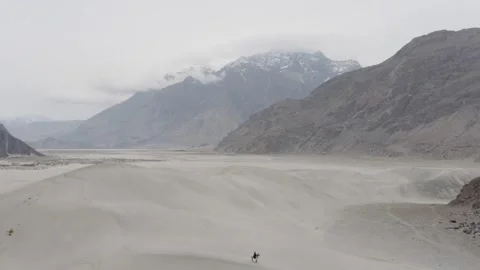 Aerial View of Snow-Capped Mountains and Desert Landscape in Pakistan, Featuring 스톡 동영상 314454155