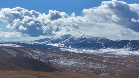 Aerial view of snow-capped mountains and alpine grasslands in Litang Stock Footage 332554862