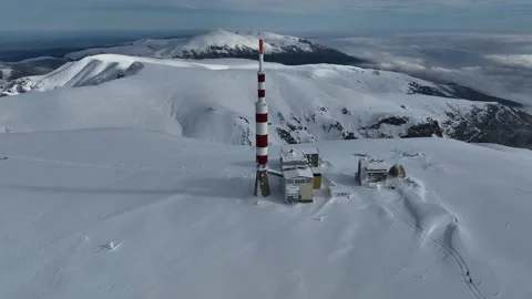 Aerial view snow-capped peaks and a communications tower with antennas Stock Footage 301693229