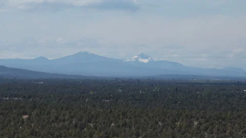 Aerial view of snow capped Three Sisters Mountains from Bend Oregon in spring 動画素材 335727783