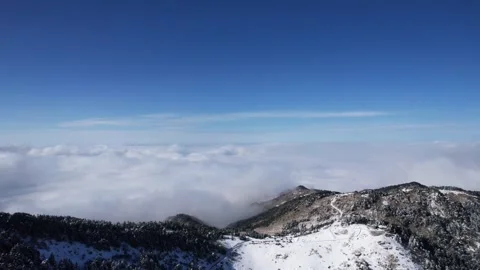 Aerial View of Snow Cliff Mountain Top High Altitude Cloud Sea in Shennongjia Stock Footage 337941044