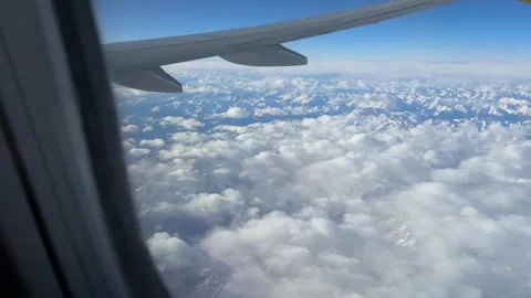 Aerial view of the snow-covered Alps seen through an airplane window Stock Footage 294103146