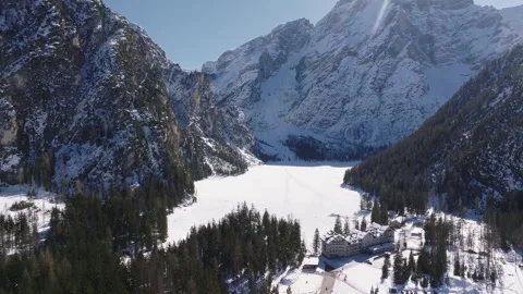Aerial View of Snow Covered Braies Lake and Surrounding Mountains Stock Footage 306521135