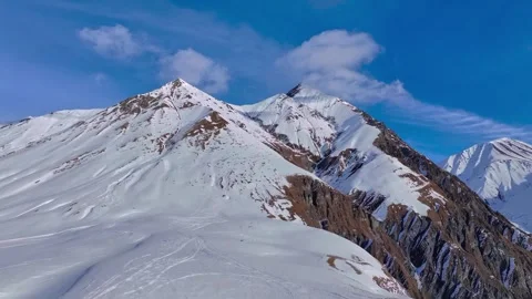 Aerial View of Snow Covered Mountain Peaks and Blue Sky 動画素材 339159283