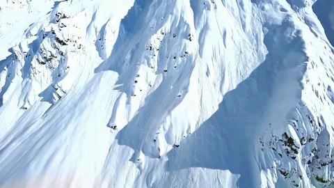 Aerial view of snow covered mountain peaks with deep winter shadows. Stock-Footage 341134537