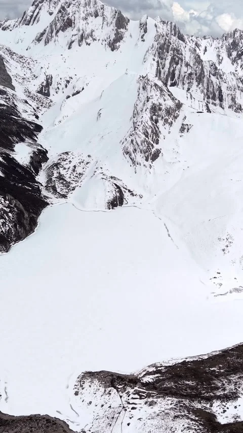 Aerial View of Snow-Covered Mountain Lake in Western Sichuan Stock Footage 346160435
