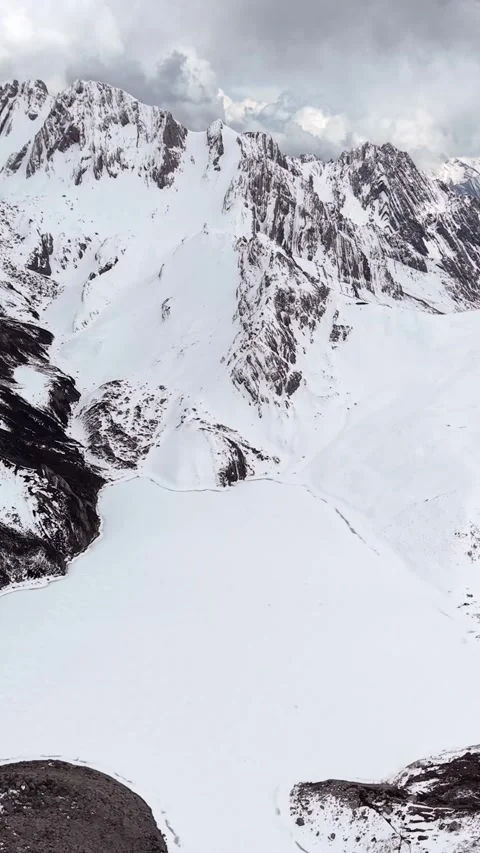 Aerial View of Snow-Covered Mountain Valley and Frozen Lake Stock Footage 346160459