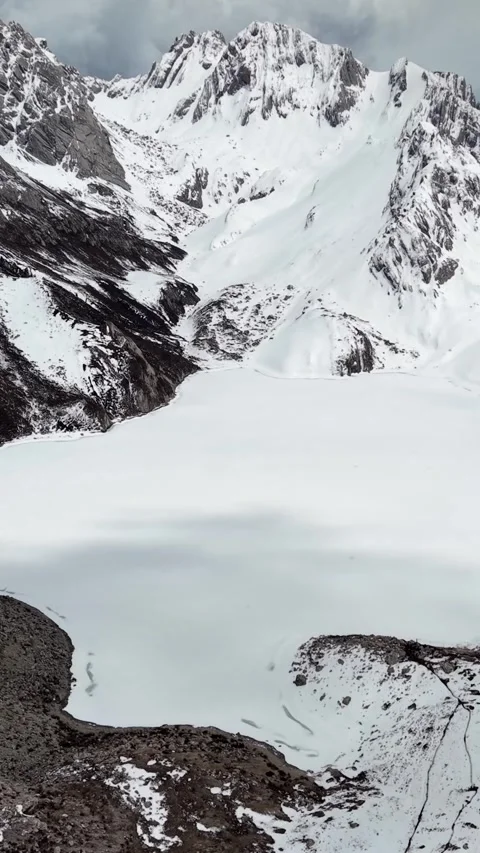 Aerial View of Snow-Covered Mountain Lake in Western Sichuan Stock Footage 346166849