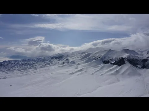 Aerial View of Snow-Covered Mountains Near Sayram Lake, Xinjiang Stock Footage 304080353
