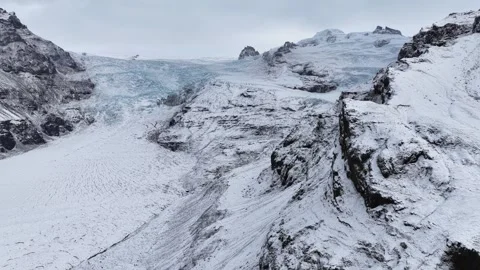 Aerial view of snow-covered mountains and glacier, Iceland. Stock Footage 320231978