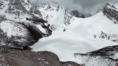 Aerial View of Snow-Covered Mountains and Frozen Lake in Qizanggou, Sichuan Stock Footage 338309065