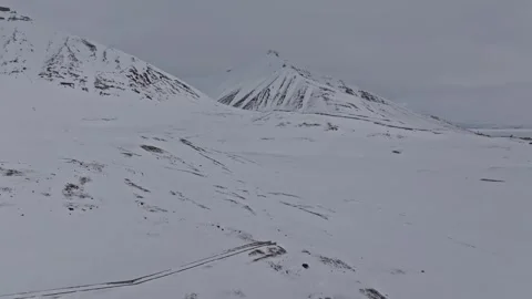 Aerial view of snow-covered mountains in Pyramiden, Svalbard and Jan Mayen. Stock Footage 346398863