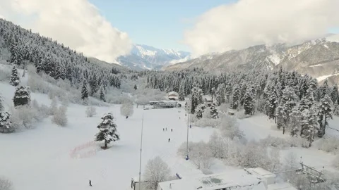 Aerial view snow covered pine forest and wooden hut near ski resort in Mest.. Stock Footage 312000283