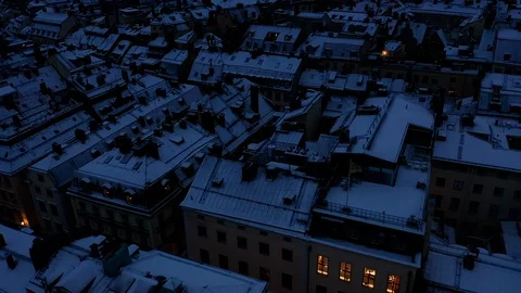 Aerial view of snow covered rooftops in the Old Town, Stockholm, nighttime . Stock Footage 129778085