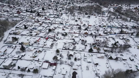 Aerial view snow covered rooftops of cottages townhouse settlement in winter day Stock Footage 262482892