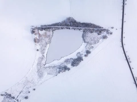 Aerial view of snow-covered triangular lake in winter, Highland, Vysocina, Czech Fotos Stock