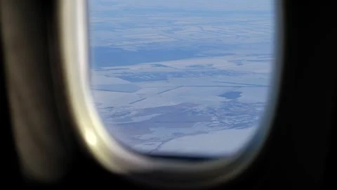 Aerial view of snow covered winter landscape and agricultural fields throug.. Video stock 338332409