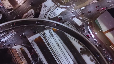 Aerial View of Snow-Dusted Streets and Glowing Traffic at Night Stock Footage 258142731