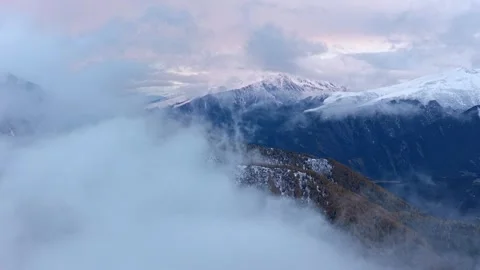 Aerial view of snow mountain above sea of clouds in autumn Stock Footage 346193473