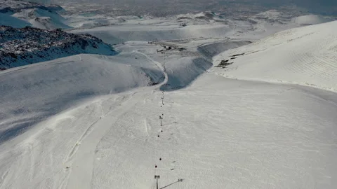 Aerial view snow mountain peak clouds in background 4k winter drone footage Ski Stock Footage 196914654