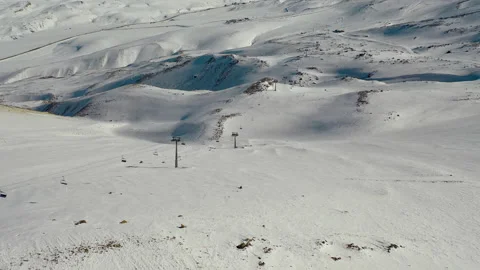 Aerial view snow mountain peak clouds in background 4k winter drone footage Ski Stock Footage 196914710