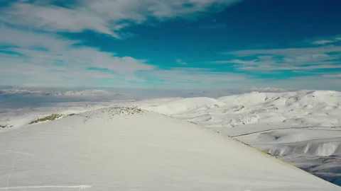Aerial view snow mountain peak clouds in background 4k winter drone footage Ski Stock Footage 196914836