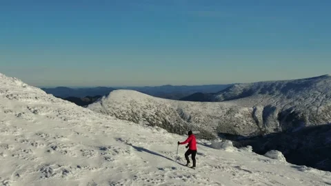 Aerial view of snow mountain range landscape. Climber Walking Up Mountain Exp Stock Footage 164722734